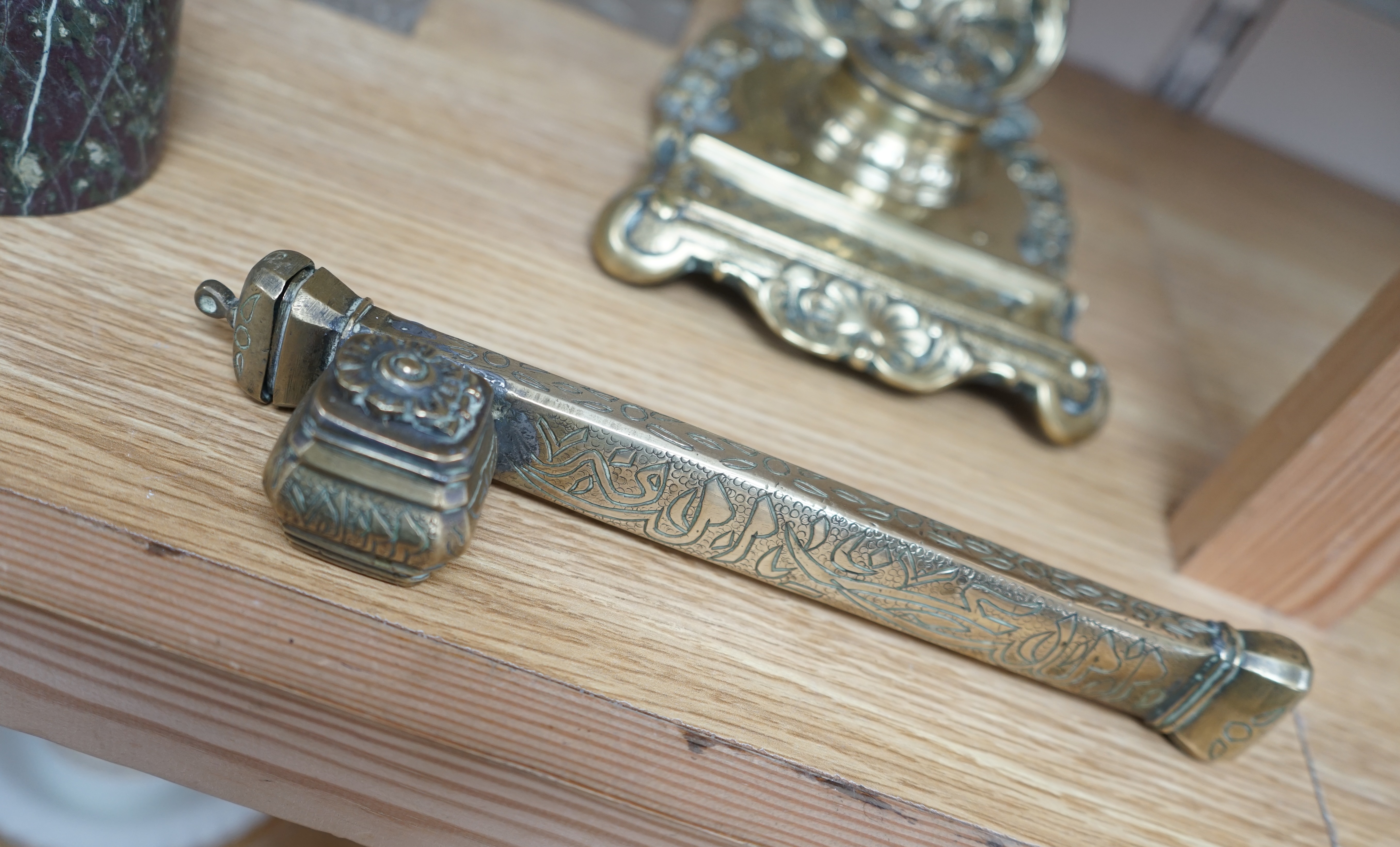 A 19th century Persian brass scribe set, a cast brass inkwell, three other inkwells, largest 24cm in length (5) Condition - poor to fair